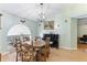 Traditional dining room featuring a classic wood table set next to a piano and a large sunlit window at 7222 Stanford Dr, Lakeland, FL 33809