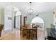 Open dining room boasts a traditional wood table set beneath an elegant light fixture and front door access at 7222 Stanford Dr, Lakeland, FL 33809