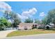 Charming one-story home with lush green lawn, mature trees, and welcoming curb appeal at 7222 Stanford Dr, Lakeland, FL 33809