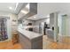 Modern kitchen with stainless appliances, sleek cabinets, breakfast bar, and open layout to living areas at 7222 Stanford Dr, Lakeland, FL 33809
