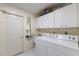 Functional laundry room with white cabinets and modern washer and dryer at 7222 Stanford Dr, Lakeland, FL 33809