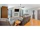 Bright living room featuring a fireplace, hardwood floors, a ceiling fan, and views of the backyard at 7222 Stanford Dr, Lakeland, FL 33809