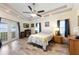 Serene main bedroom with French doors, ceiling fan, and a soothing color palette for optimal relaxation at 7222 Stanford Dr, Lakeland, FL 33809