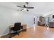 Functional home office area includes desk, chair, ceiling fan, and seamless access to adjacent living spaces at 7222 Stanford Dr, Lakeland, FL 33809