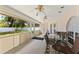 Enclosed patio with tiled flooring, ceiling fans, and views of the landscaped backyard at 7222 Stanford Dr, Lakeland, FL 33809