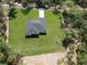 Expansive aerial view showcases a lush green lawn, complemented by the home's modern roof and private driveway at 814 Gator Ln, Deltona, FL 32738