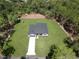 Aerial view of a home on a spacious lot, surrounded by lush green trees, offering privacy and serenity at 814 Gator Ln, Deltona, FL 32738