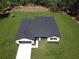 Aerial view of a well-maintained single-Gathering home with a lush lawn, dark roof, and attached garage at 814 Gator Ln, Deltona, FL 32738