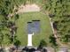Home aerial view with lots of surrounding trees and a well-manicured lawn at 814 Gator Ln, Deltona, FL 32738