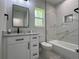 Modern bathroom featuring white cabinets, marble countertops, and a tub at 814 Gator Ln, Deltona, FL 32738