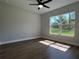 Cozy bedroom featuring wood-look floors and a bright window at 814 Gator Ln, Deltona, FL 32738