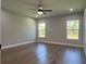 Bright bedroom with two large windows and wood-look flooring at 814 Gator Ln, Deltona, FL 32738