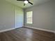 Inviting bedroom with a closet, bright window, and wood-look flooring at 814 Gator Ln, Deltona, FL 32738
