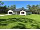 Quaint one-story home with attached garage, manicured lawn, and tasteful landscaping at 814 Gator Ln, Deltona, FL 32738