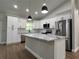 Modern kitchen with white cabinets, marble countertops, stainless steel appliances, and center island at 814 Gator Ln, Deltona, FL 32738
