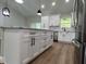 Kitchen with stainless steel appliances, white cabinets, granite countertops, and a functional center island at 814 Gator Ln, Deltona, FL 32738