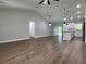 Spacious living area showcases new wood flooring, recessed lights, and a view into the modern, white kitchen at 814 Gator Ln, Deltona, FL 32738