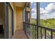 Private balcony showcasing a peaceful outdoor seating area with verdant views at 9055 Treasure Trove Ln # 409, Kissimmee, FL 34747