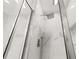 Modern bathroom showcasing marble tile and a luxurious rainfall shower head behind sleek glass doors at 9055 Treasure Trove Ln # 409, Kissimmee, FL 34747