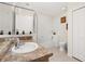 Bright bathroom featuring a combination shower and tub with glass enclosure, neutral-toned tiles, and double door closet at 9055 Treasure Trove Ln # 409, Kissimmee, FL 34747