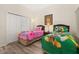 Shared bedroom with twin beds, fun colorful decor, closet, and a cozy atmosphere at 9055 Treasure Trove Ln # 409, Kissimmee, FL 34747