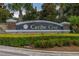 Elegant Caribe Cove entrance sign surrounded by lush greenery and landscaping at 9055 Treasure Trove Ln # 409, Kissimmee, FL 34747