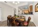 Cozy dining area featuring a set dining table, wood flooring, with kitchen access at 9055 Treasure Trove Ln # 409, Kissimmee, FL 34747