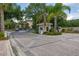 Gated community entrance featuring landscaped surroundings and a security gatehouse for added privacy at 9055 Treasure Trove Ln # 409, Kissimmee, FL 34747