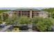 Building aerial view showcases this condo exterior in a parking lot surrounded by lush greenery and palm trees at 9055 Treasure Trove Ln # 409, Kissimmee, FL 34747