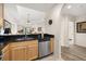 Updated kitchen featuring stainless steel dishwasher, granite countertops and wood cabinetry at 9055 Treasure Trove Ln # 409, Kissimmee, FL 34747