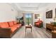 Comfortable living room boasting natural light, a tray ceiling, and calming interior decor at 9055 Treasure Trove Ln # 409, Kissimmee, FL 34747