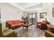 Cozy living room with modern flooring, comfortable seating, balcony access, and abundant natural light at 9055 Treasure Trove Ln # 409, Kissimmee, FL 34747