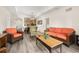 Inviting living room featuring cozy seating, warm wood accents and an open layout concept at 9055 Treasure Trove Ln # 409, Kissimmee, FL 34747