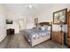 A primary bedroom featuring wooden furniture, hard wood floors, and an ensuite bathroom at 9055 Treasure Trove Ln # 409, Kissimmee, FL 34747