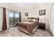 Serene main bedroom features a balcony, dark wood furniture, and an inviting, comfortable feel at 9055 Treasure Trove Ln # 409, Kissimmee, FL 34747