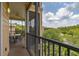 Comfortable screened-in patio with black metal railings and serene views of nature and nearby buildings at 9055 Treasure Trove Ln # 409, Kissimmee, FL 34747