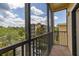 Relax on this screened-in patio with views of lush greenery, blue skies and a building nearby at 9055 Treasure Trove Ln # 409, Kissimmee, FL 34747