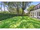 Spacious green backyard surrounded by lush greenery, perfect for outdoor activities and serene relaxation at 9799 Covent Garden Dr, Orlando, FL 32827
