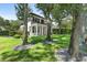 Lush backyard with mature trees surrounding the manicured lawn, creating a private and serene outdoor retreat at 9799 Covent Garden Dr, Orlando, FL 32827