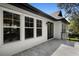 Exterior view showcasing a tiled balcony and French doors complementing the bright, modern design at 9799 Covent Garden Dr, Orlando, FL 32827