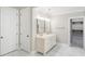 Spacious bathroom featuring a double sink vanity, marble floors, and a walk-in closet at 9799 Covent Garden Dr, Orlando, FL 32827