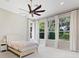 Bright bedroom with large windows, neutral decor, and a ceiling fan at 9799 Covent Garden Dr, Orlando, FL 32827