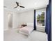 Inviting bedroom featuring carpeted floors, modern furnishings, and large windows for natural light at 9799 Covent Garden Dr, Orlando, FL 32827