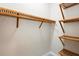Spacious walk-in closet offering ample wood shelving for optimal storage and organization at 9799 Covent Garden Dr, Orlando, FL 32827