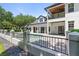 Elegant home boasts a second story covered balcony, lush landscaping, and an attached garage at 9799 Covent Garden Dr, Orlando, FL 32827