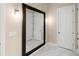 Bright hallway featuring a large mirror and marble floors at 9799 Covent Garden Dr, Orlando, FL 32827