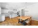 Bright open kitchen featuring stainless appliances, marble countertops, an eat-in table, and wooden floors at 9799 Covent Garden Dr, Orlando, FL 32827