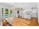 Bright, open kitchen featuring white cabinets, stainless appliances, marble countertops, and access to outdoor pool at 9799 Covent Garden Dr, Orlando, FL 32827