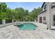 Beautiful backyard pool and spa with stone patio and lush landscaping at 9799 Covent Garden Dr, Orlando, FL 32827