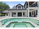 View of the backyard pool and spa with elegant patio and columns at 9799 Covent Garden Dr, Orlando, FL 32827
